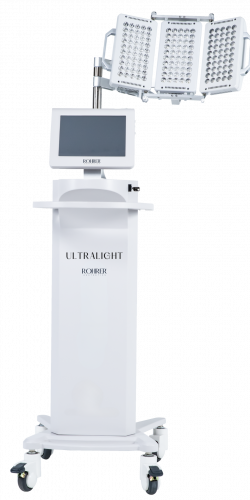 Rohrer Aesthetics UltraLight Device, a white LED light therapy machine with a touchscreen monitor and an adjustable LED panel head, designed for post-procedure healing, reducing inflammation, and improving skin health.